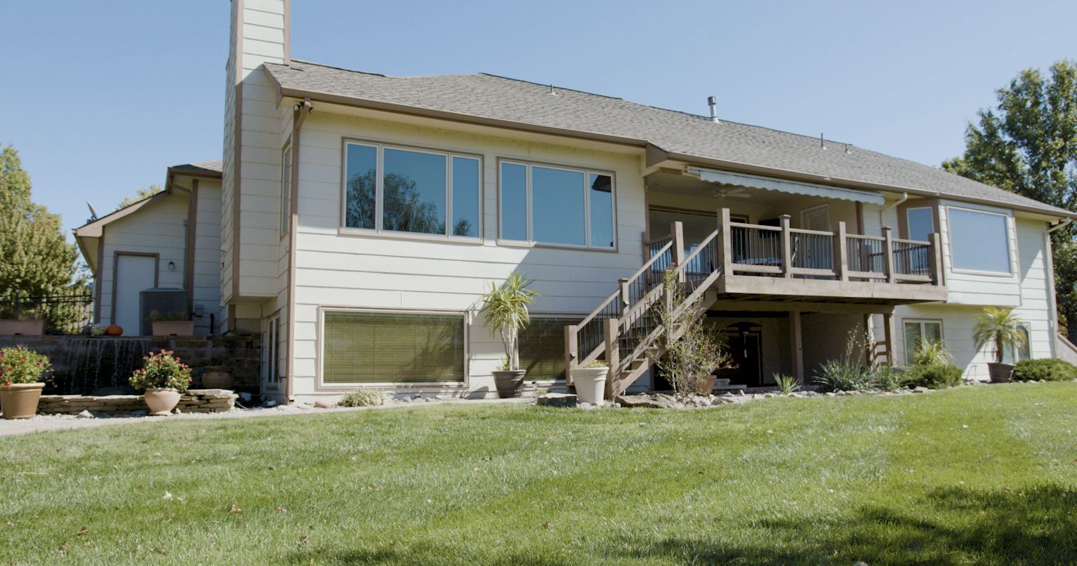 tan house with two story back deck