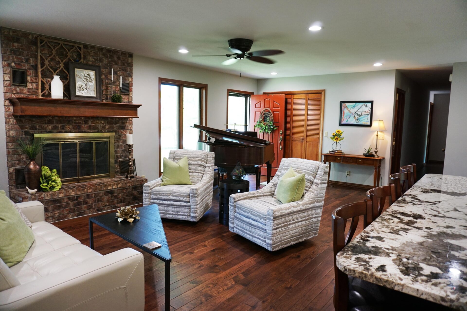 living room with brick fireplace and wood floor